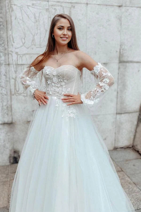 Detailed view of A-line sweetheart lace wedding gown with detachable sleeves.
