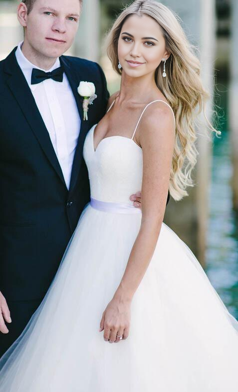 Back view of ivory tulle bridal gown with flowing skirt.
