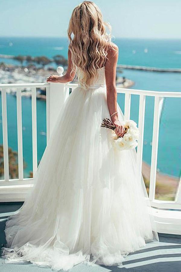 Close-up of sweetheart neckline and tulle fabric on ivory wedding dress.