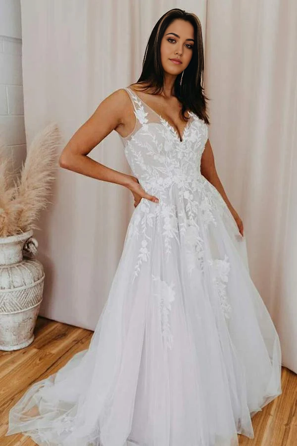 A-line V-neck wedding dress with tulle skirt and lace appliques.
