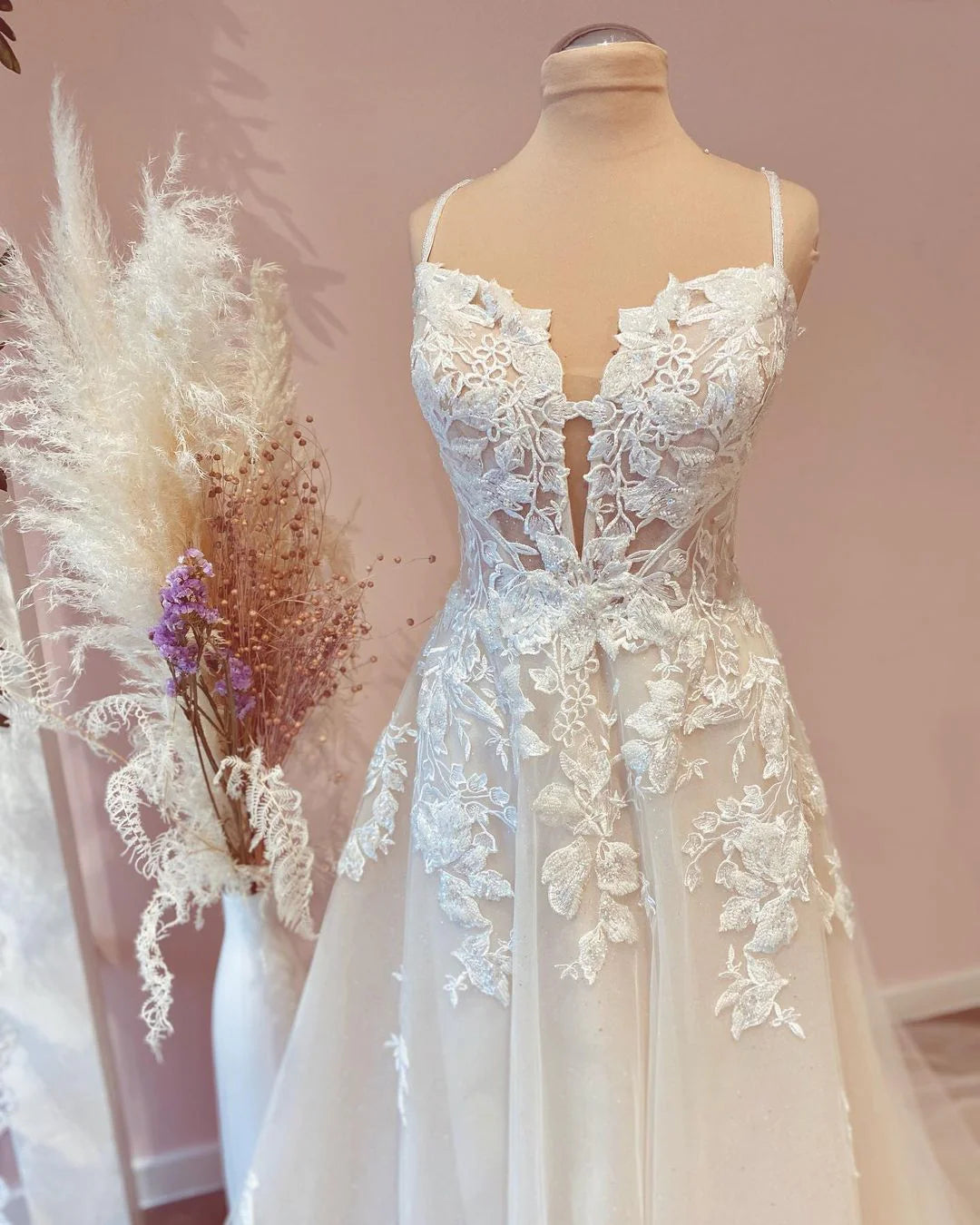 Close-up of the lace appliques and tulle fabric on the A-line wedding dress.