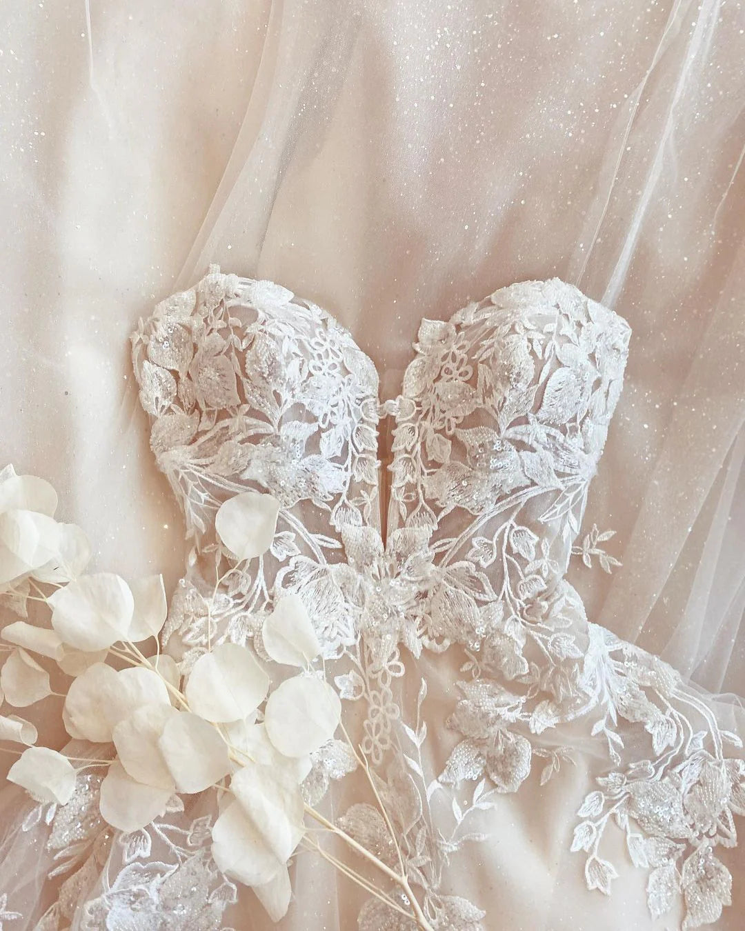 Back view of the long A-line wedding dress showing the flowing tulle skirt.