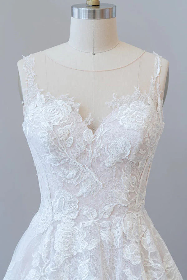 Full length view of a romantic A-line bridal gown with delicate lace and tulle.