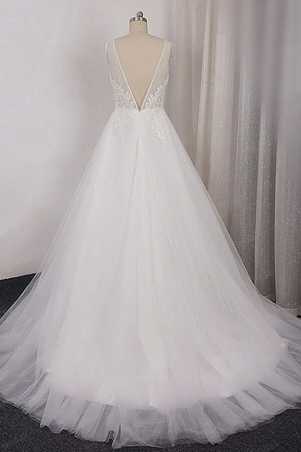 Back view of an A-line V-neck lace and tulle wedding dress with a graceful train.