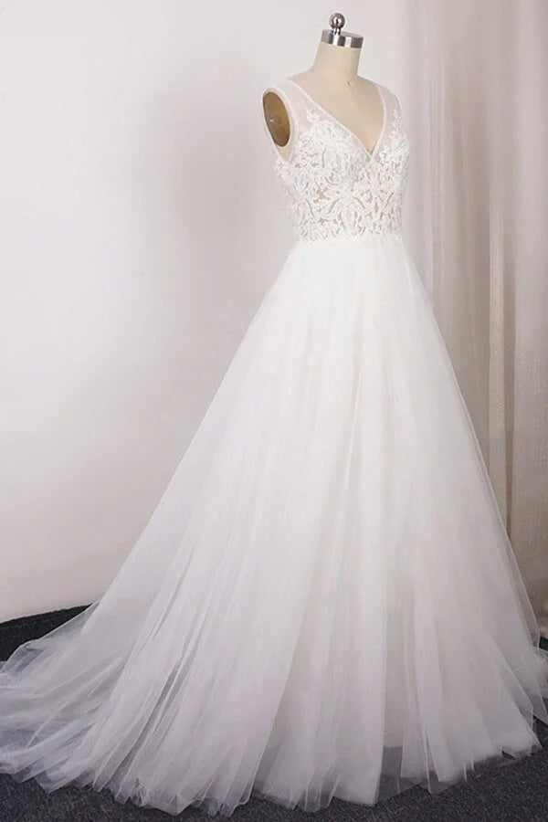 Close-up of the delicate lace appliques on the V-neck bodice of the wedding dress.