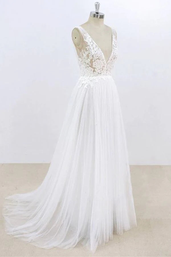 Close-up of lace and tulle fabric on A-line V-neck wedding dress.
