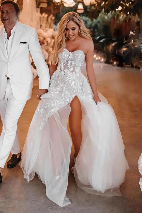 Back view of the long A-line wedding dress with a flowing train.