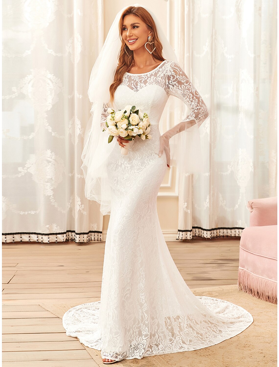 Close-up of intricate lace detail on the long sleeve of the wedding dress.