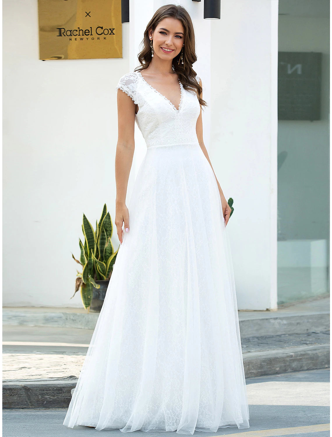 Elegant A-line lace beach wedding dress with V-neck and cap sleeves.