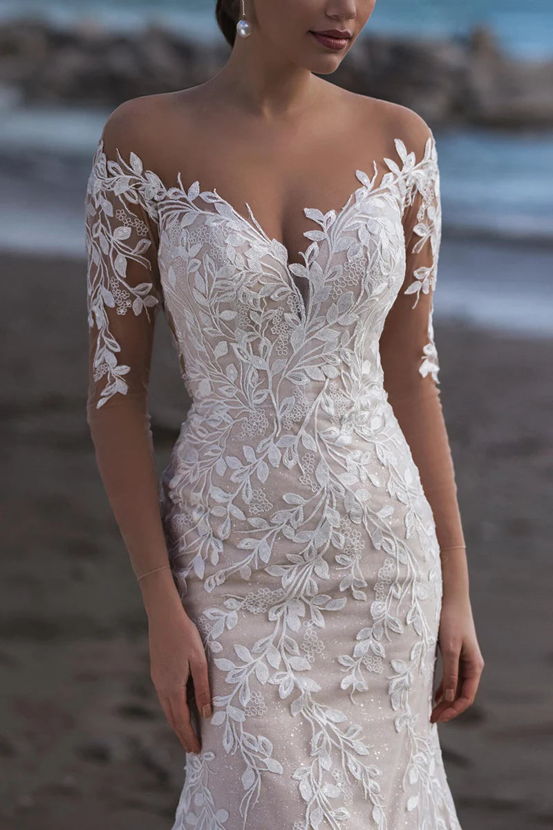 Close-up of the intricate lace detailing on the mermaid wedding dress, showing the sweetheart off-shoulder neckline.