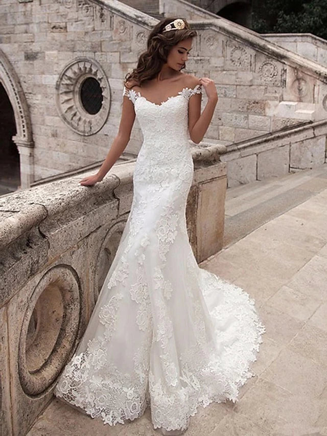 Back view of the mermaid wedding dress showing open back and court train.