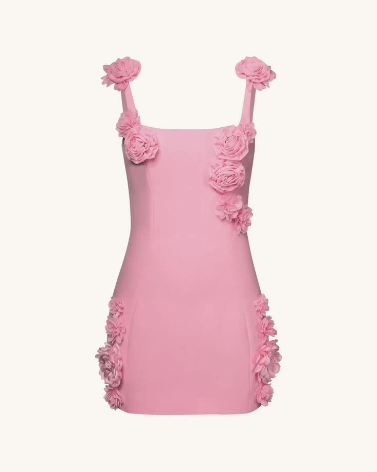 Close-up of 3D floral appliques on pink strapless mini dress.