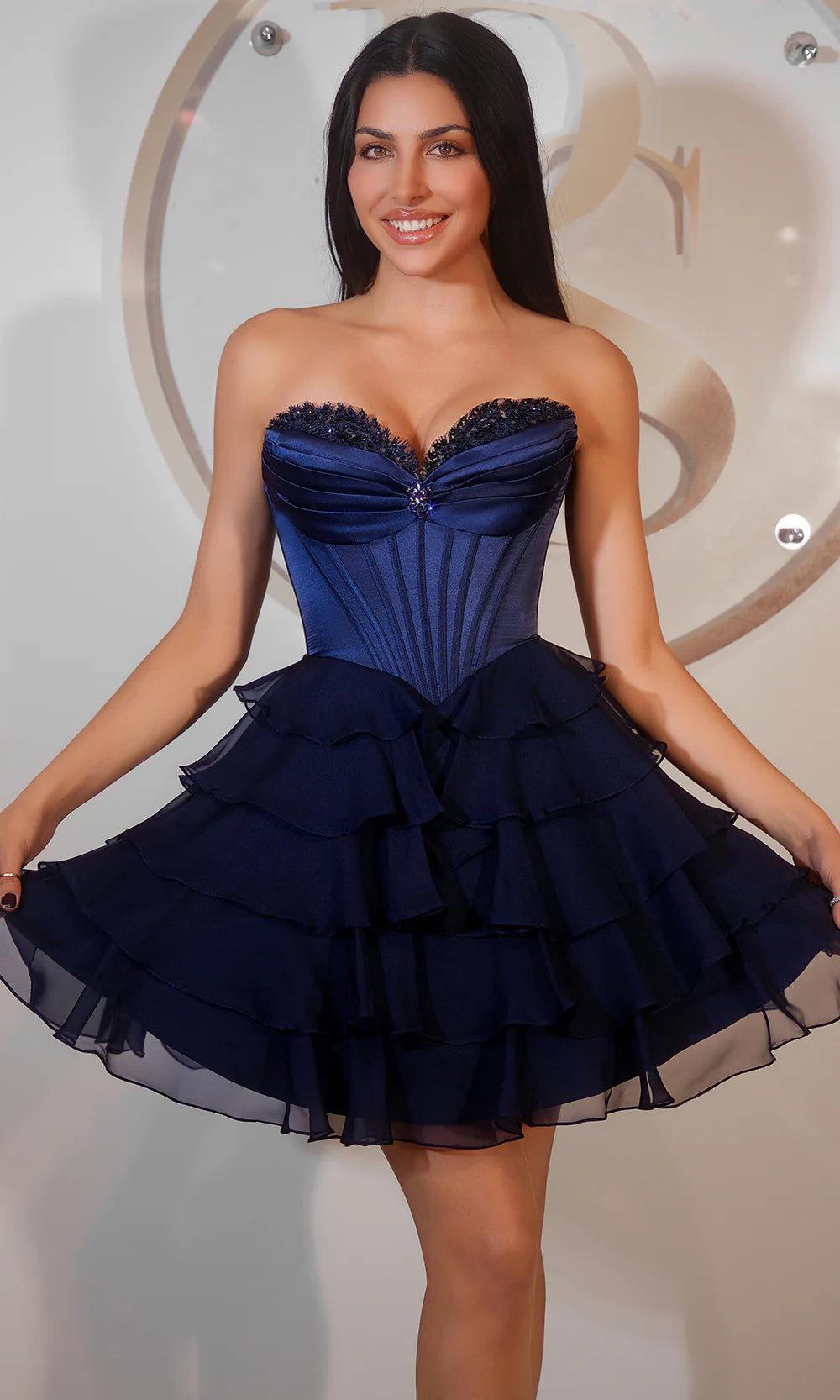 Full view of a pink strapless tiered tulle mini homecoming dress, showcasing the A-line silhouette.
