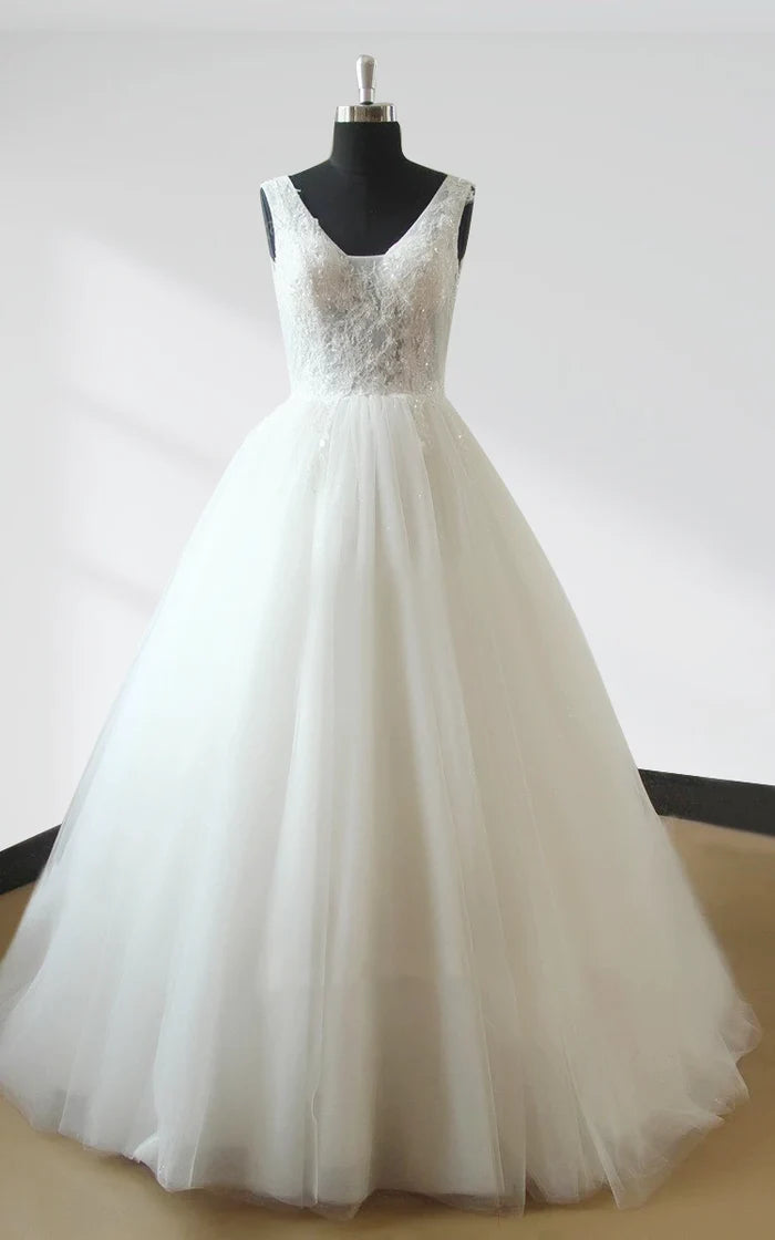 Elegant white ball gown wedding dress with sweetheart neckline and lace bodice.