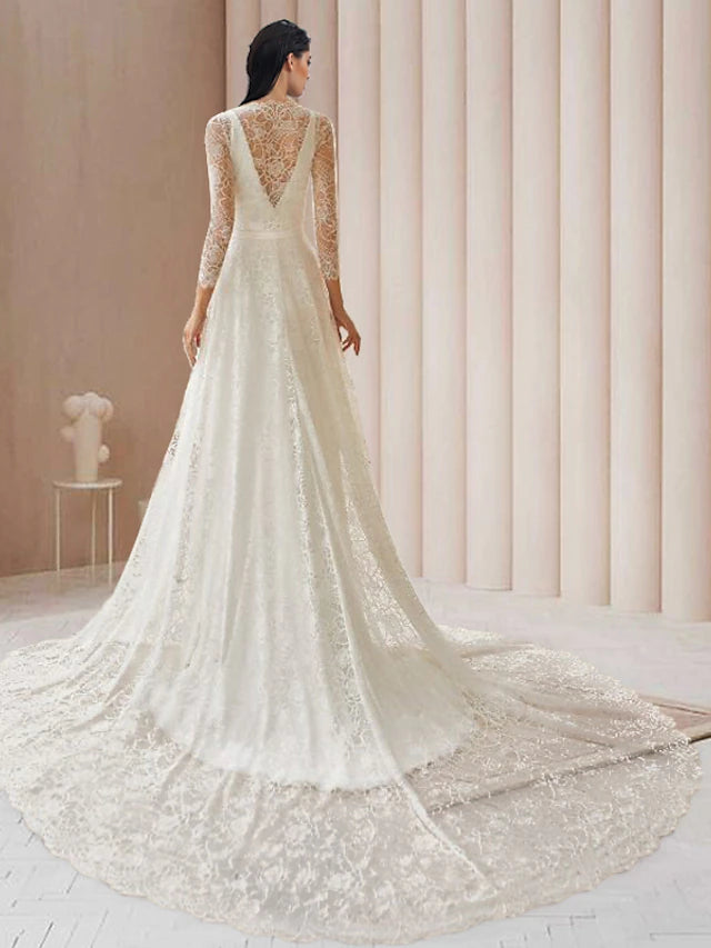 Close-up of lace detail and V-neckline on a bridal gown.