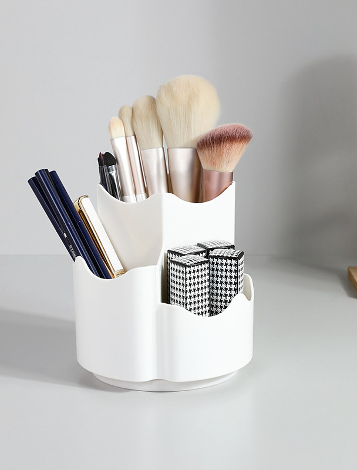 Rotary cosmetic storage box with multiple compartments.