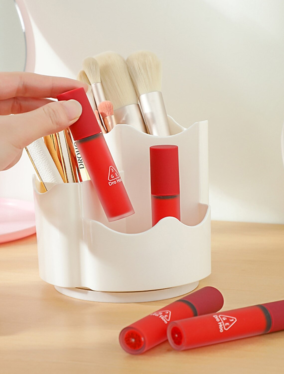 Cosmetic organizer rotating on a dresser.