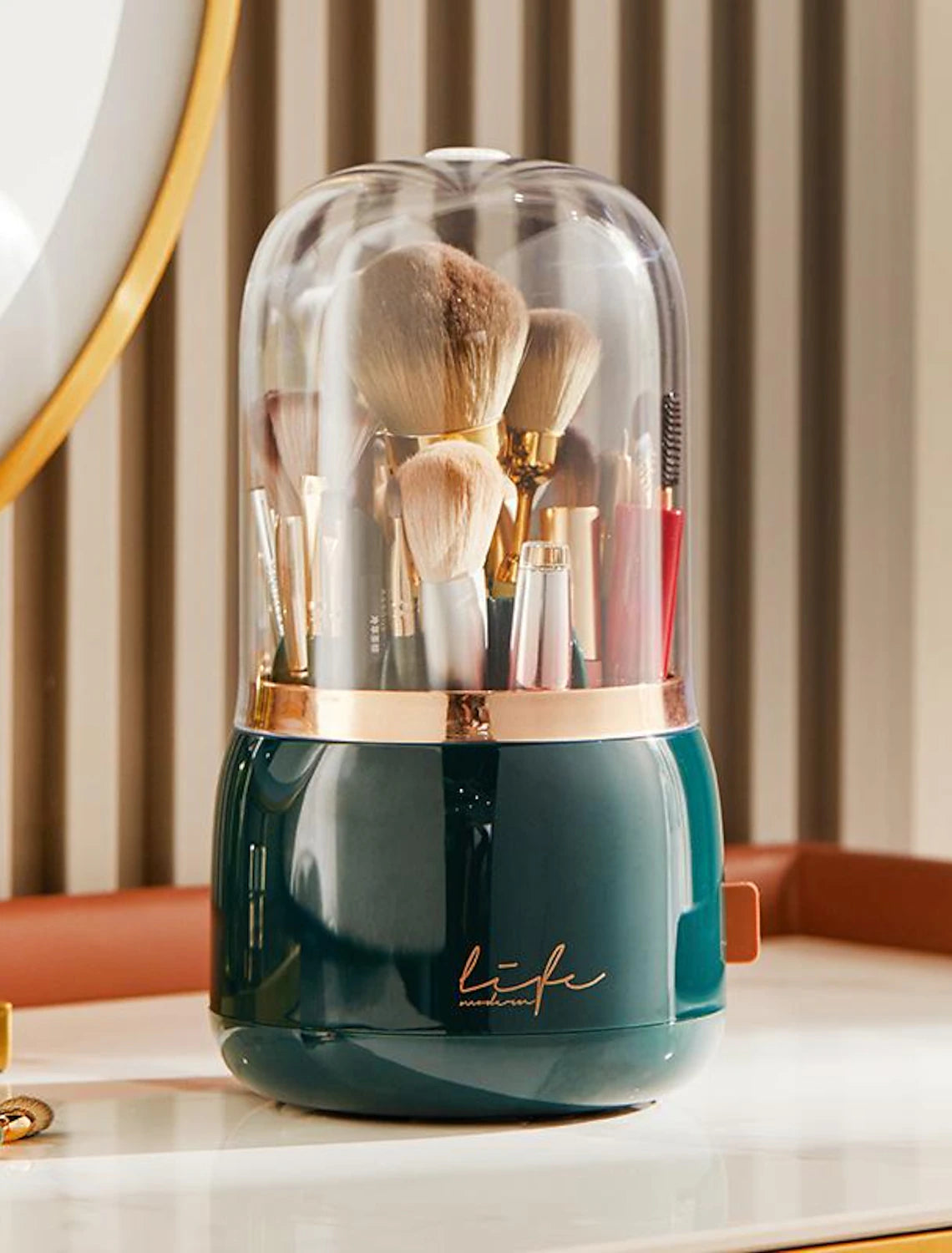 Rotating cosmetic brush organizer with lid, filled with various makeup brushes.