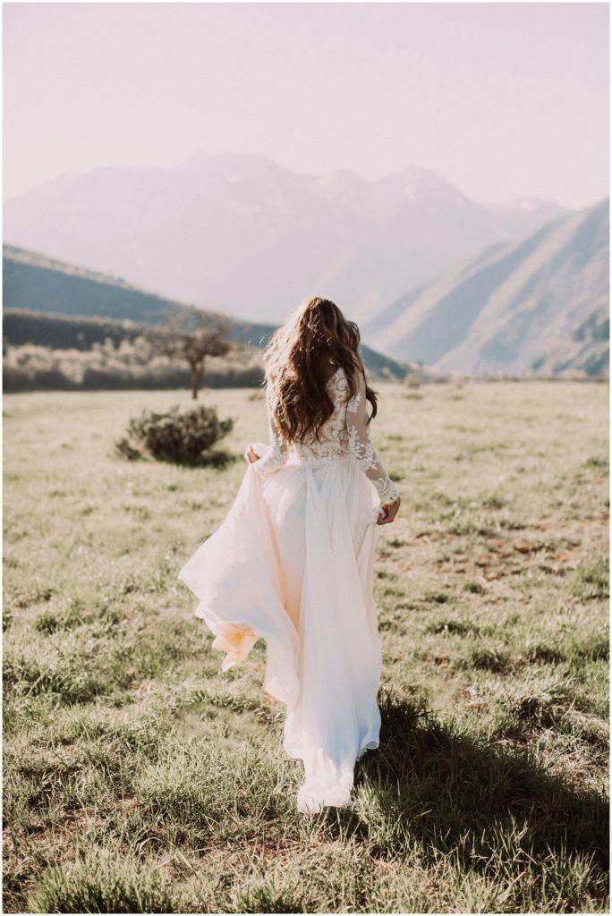 Bride wearing a rustic A-line lace long sleeve wedding gown.
