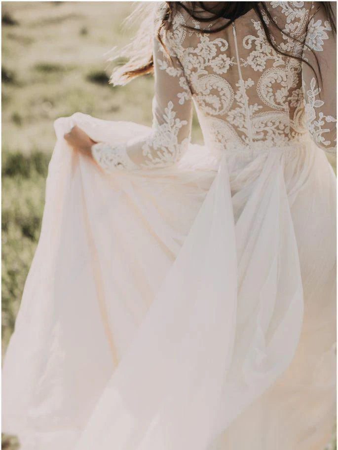 Bride posing in an A-line scoop neck long sleeve bridal gown.
