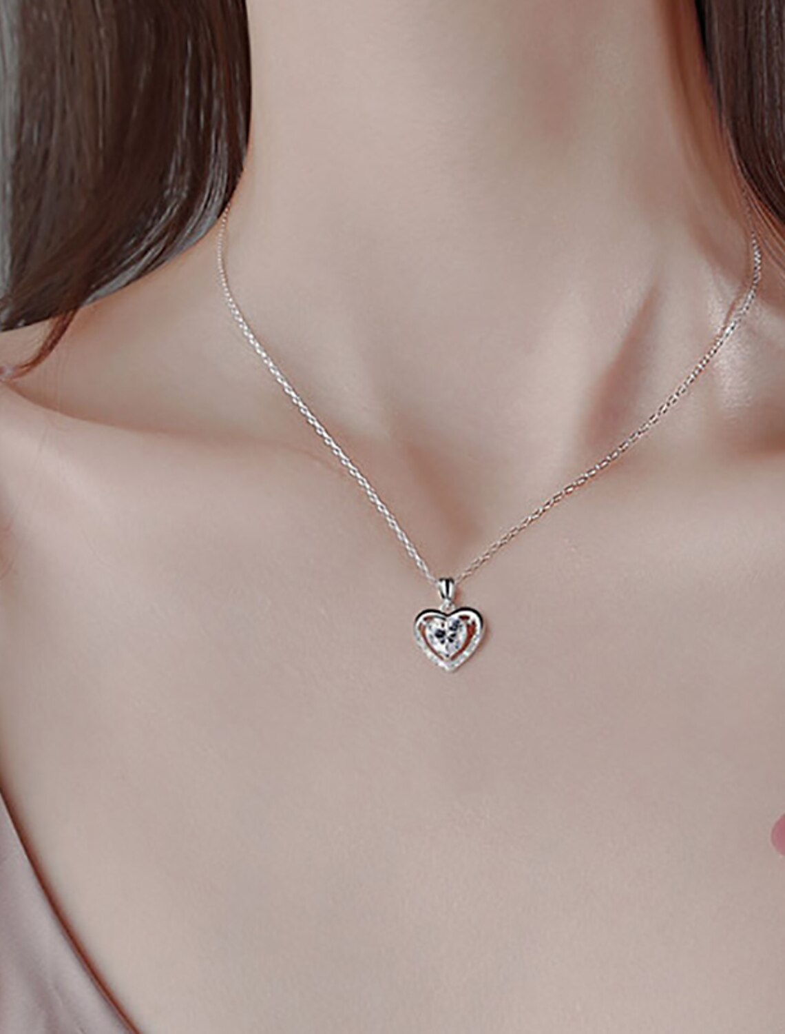 Close-up of S925 sterling silver heart pendant with rhinestones.