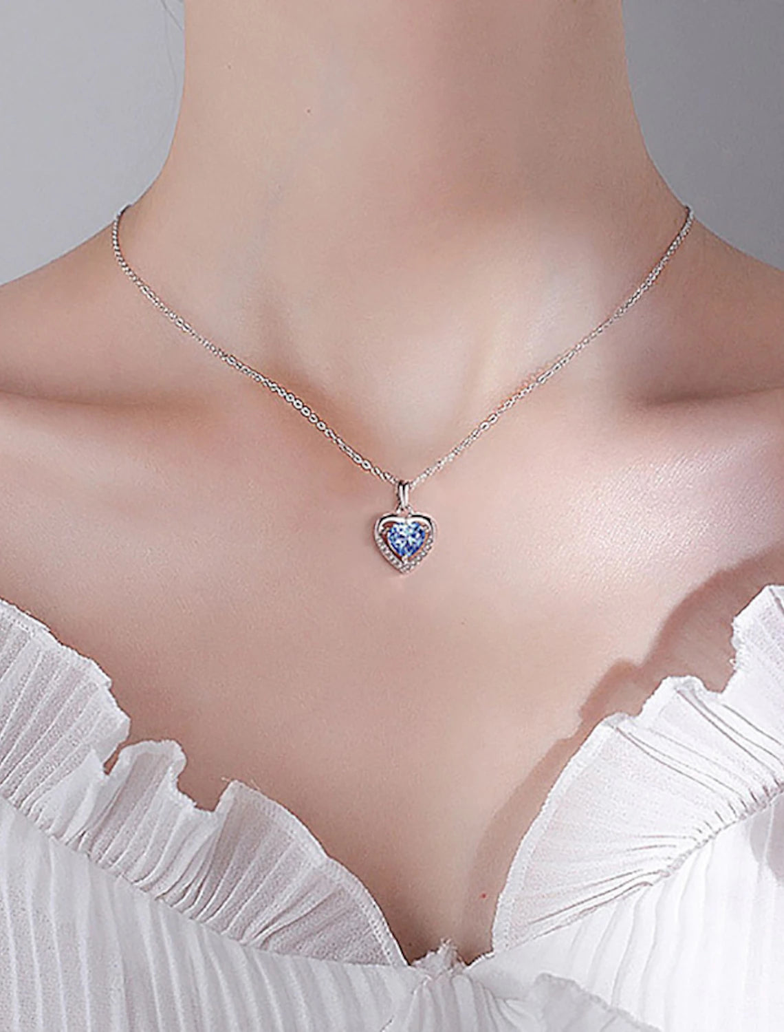 Model wearing S925 sterling silver heart pendant necklace.