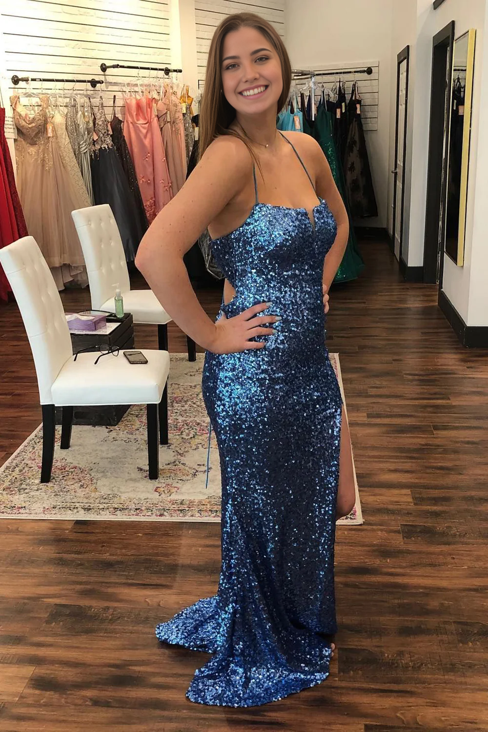 Sequined navy A-line prom dress with spaghetti straps and a flowing skirt.