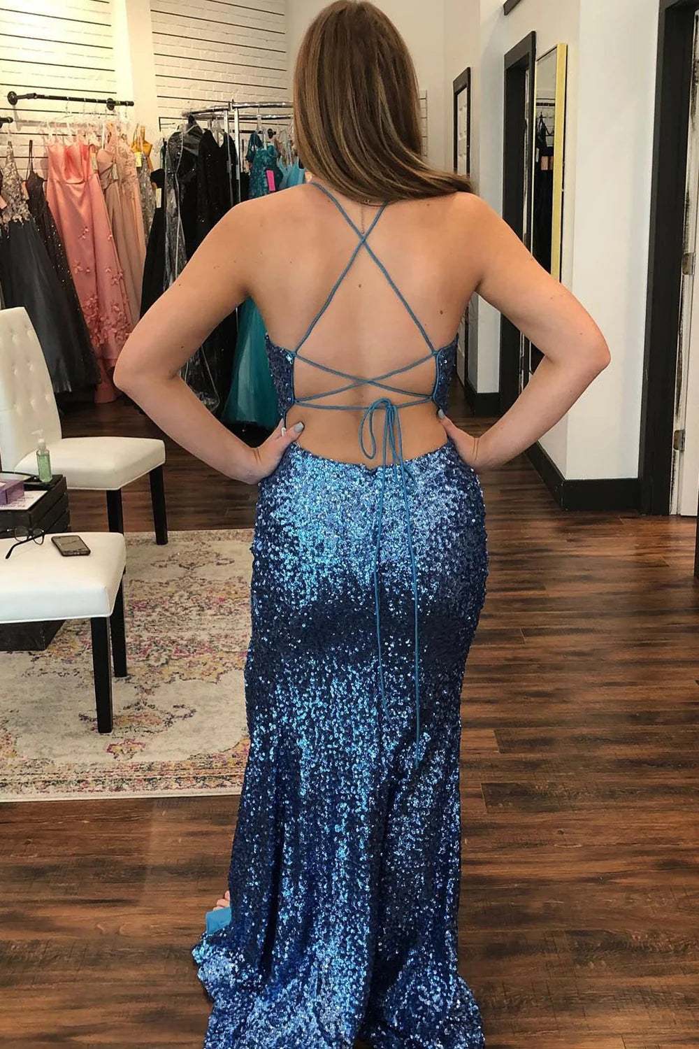 Back view of a sequined navy prom dress featuring elegant criss-cross straps.