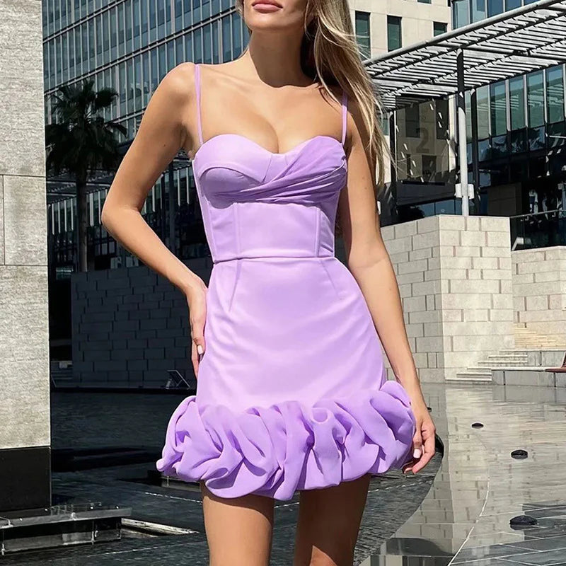 Short ruched homecoming dress with spaghetti straps and a pleated skirt.