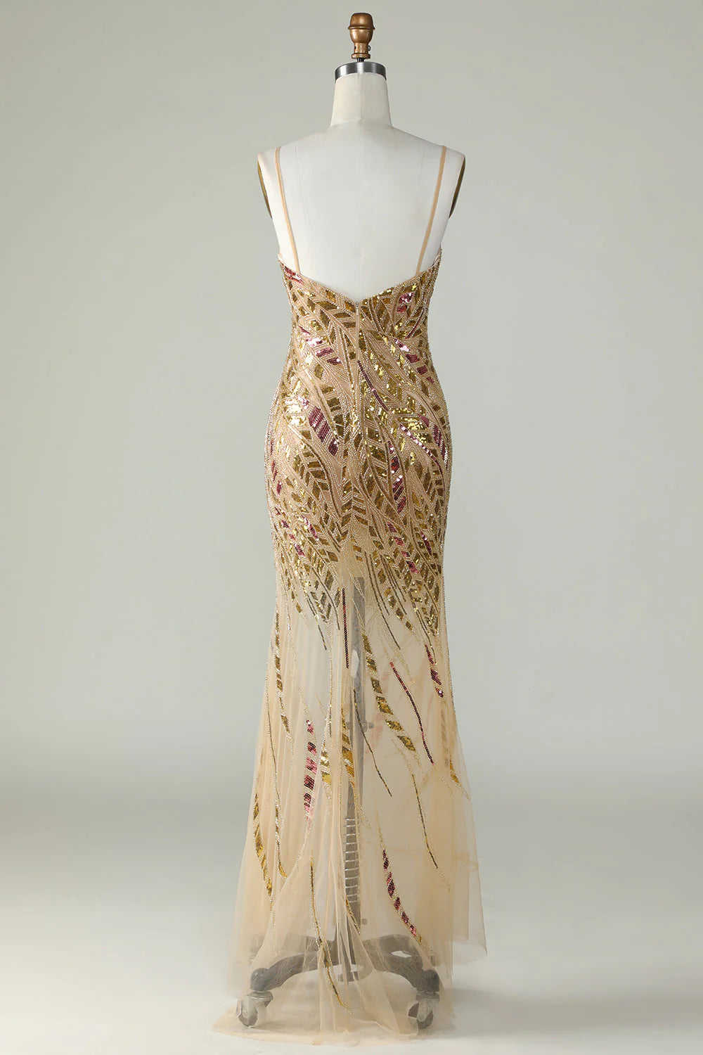Side view of golden mermaid sequins gown with elegant train.