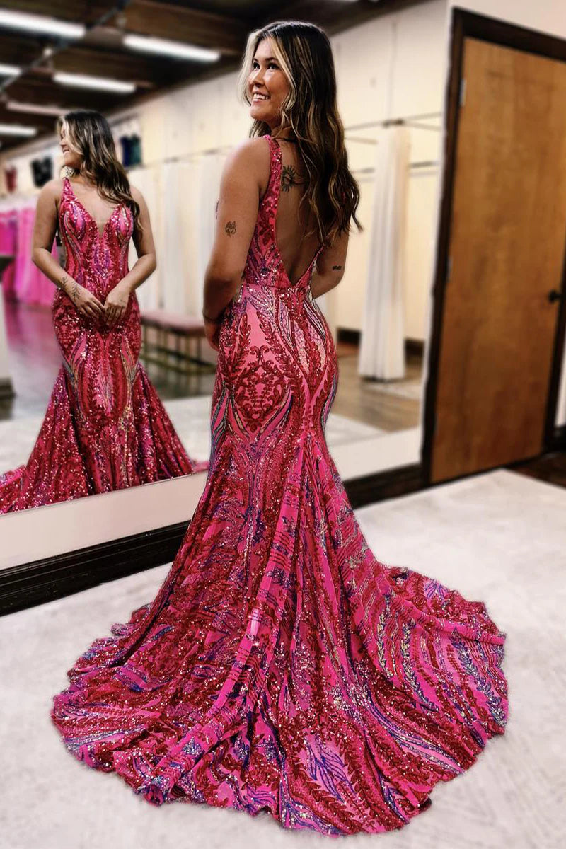 Back view of a woman in a sequin mermaid long prom dress.