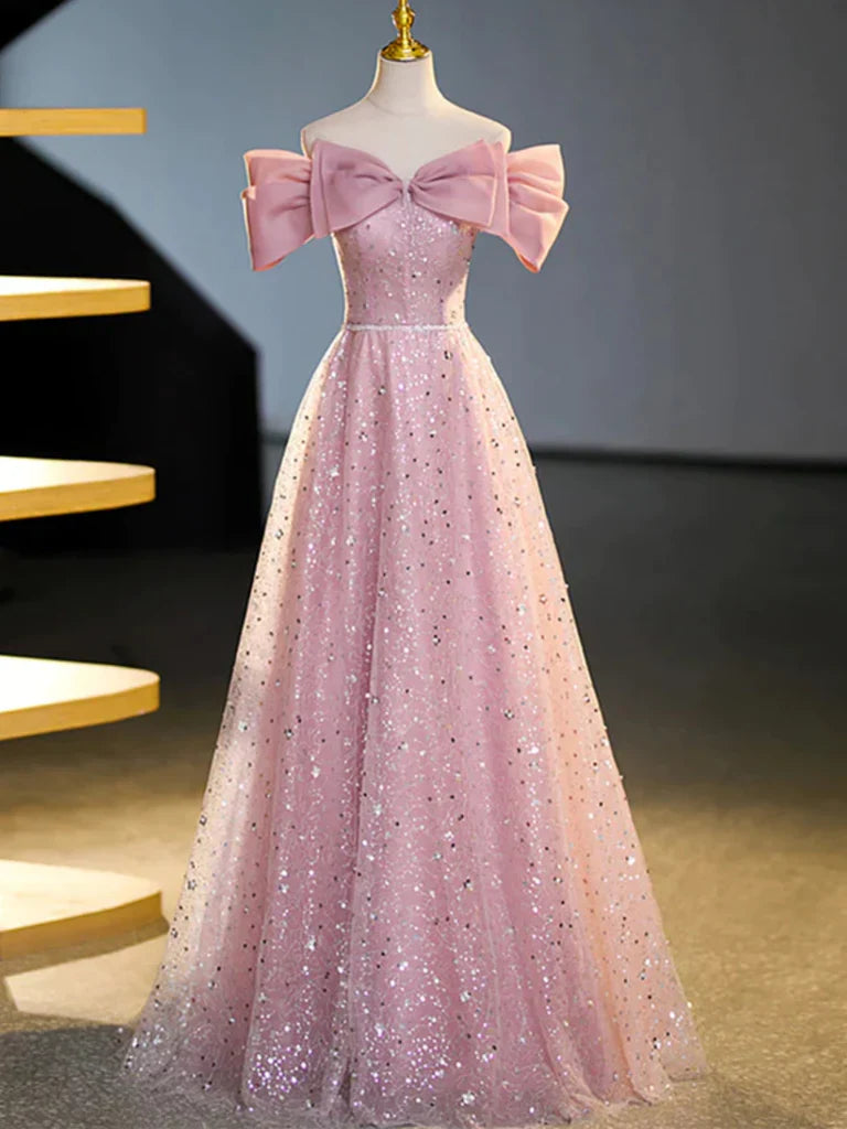 A woman wearing a sparkling off-shoulder A-line long prom dress.