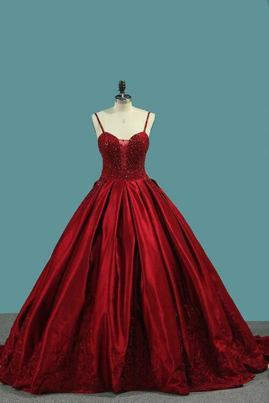 Elegant satin prom dress with spaghetti straps and crystal beading.