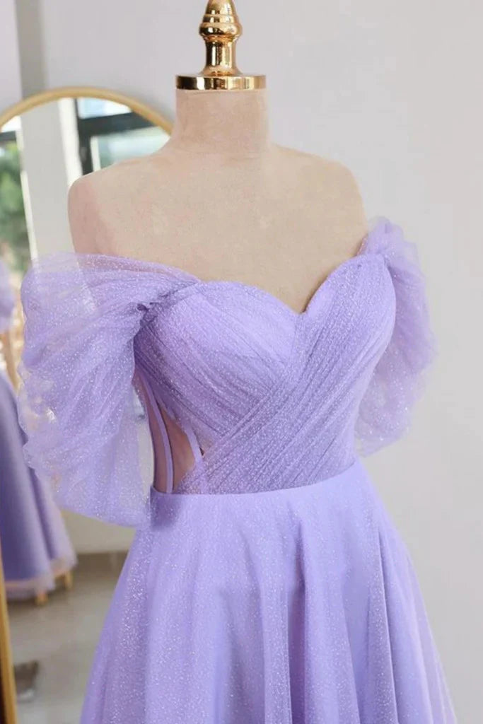 Close-up of the shiny tulle fabric and off-shoulder neckline of the dress.