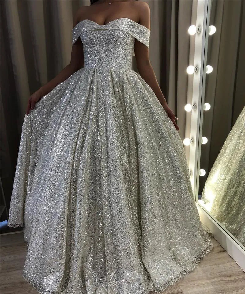 Elegant A-line off-the-shoulder sequin wedding dress.