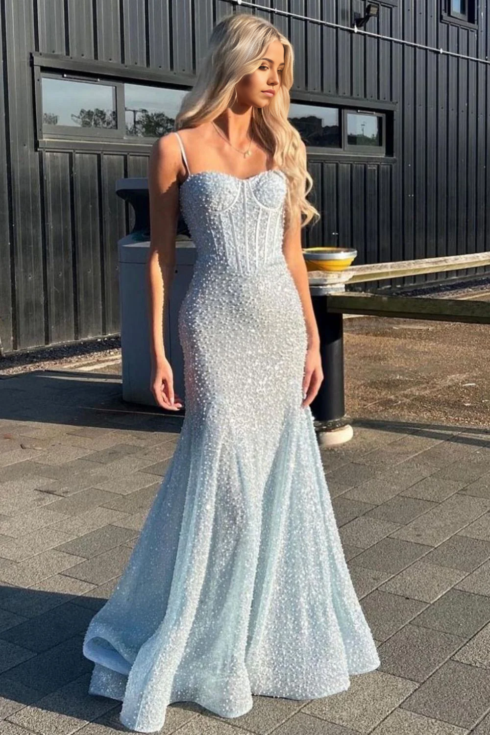 Close-up of the shiny beading on a light blue mermaid prom dress.