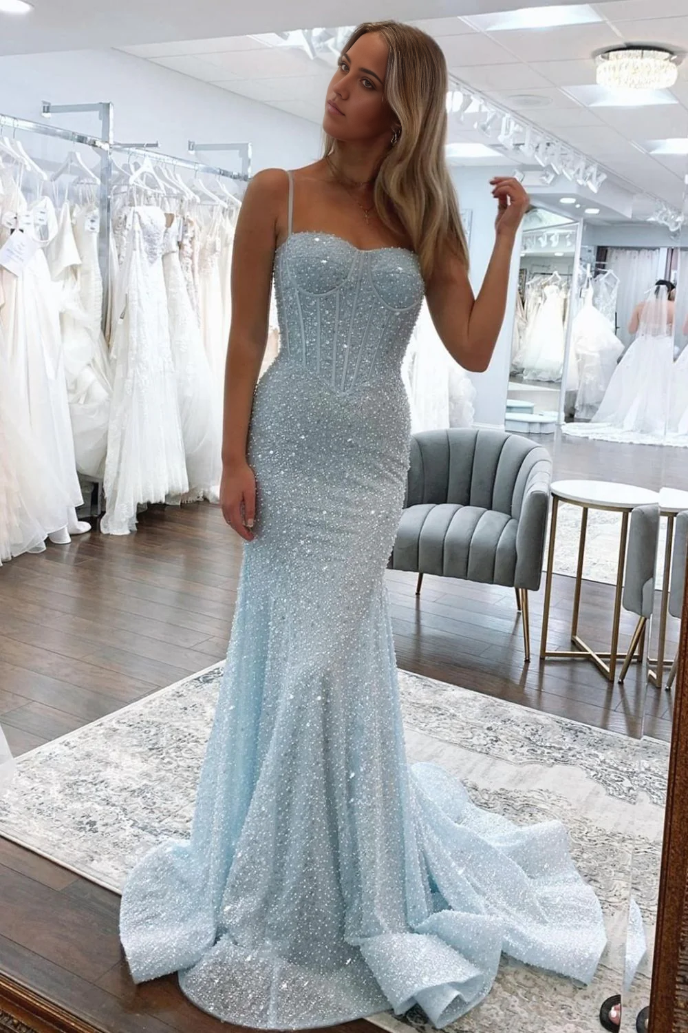 Full length view of a model posing in a light blue mermaid prom dress.