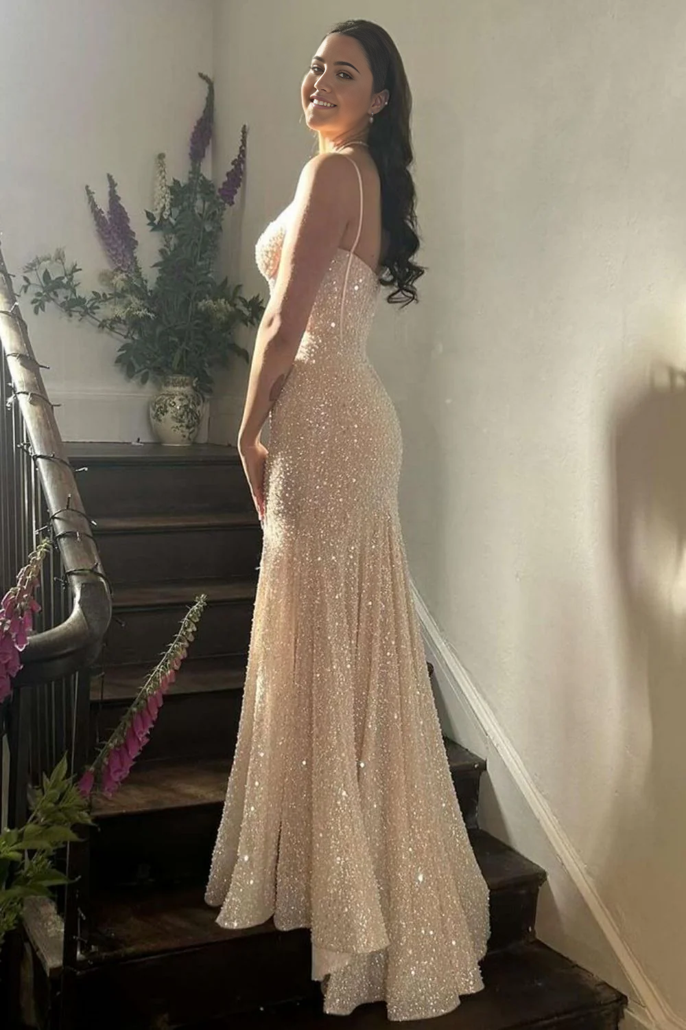 Front view of a model in a light blue mermaid prom dress with spaghetti straps.