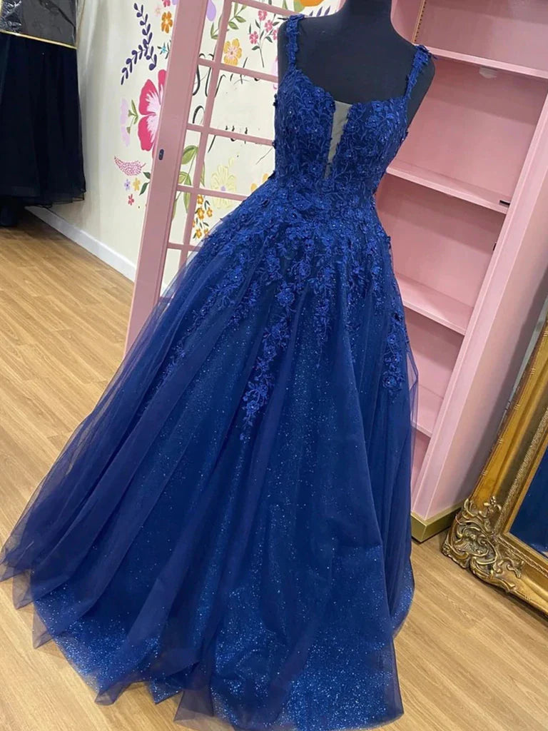 Woman wearing a shiny lace A-line V-neck formal prom dress.