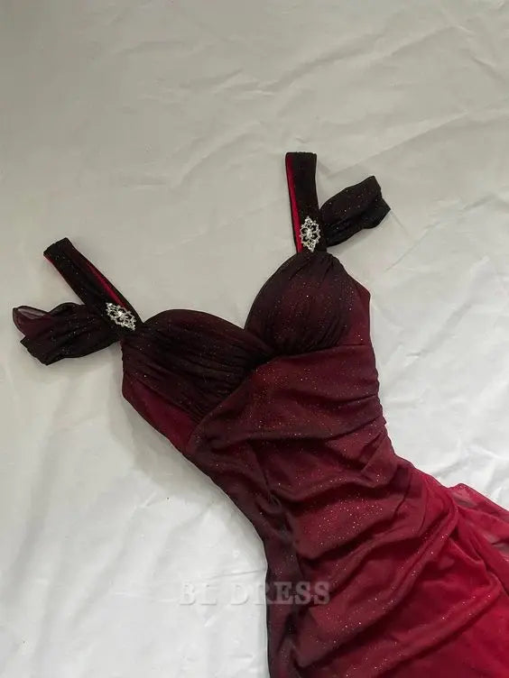 Side view of a woman in a burgundy V-neck formal gown, showcasing the flowing skirt.