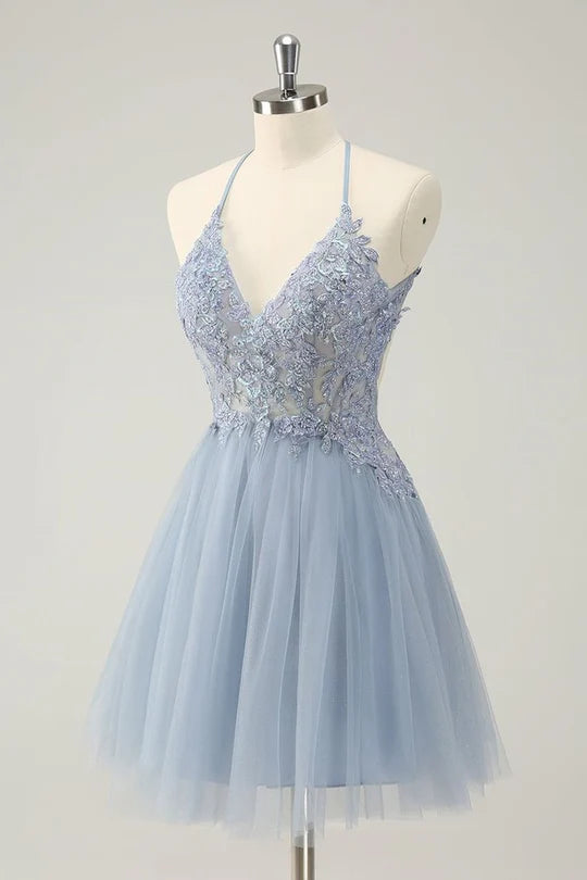 Close-up of elegant floral appliques on sparkly A-line halter dress.