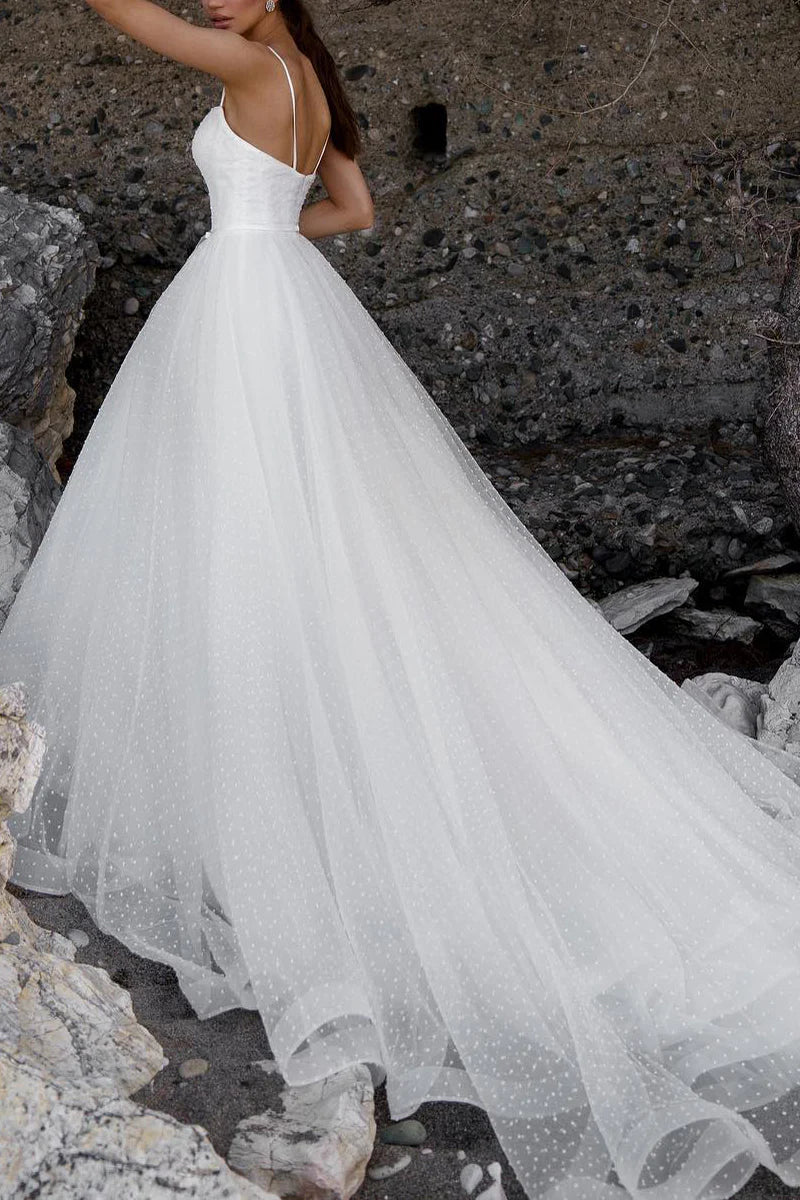 Back view of the A-line spaghetti strap wedding dress on a model.