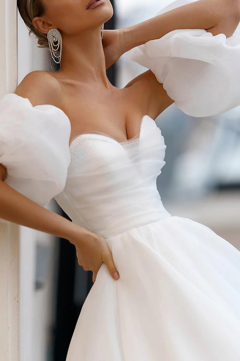 Side profile of elegant A-line bridal gown.