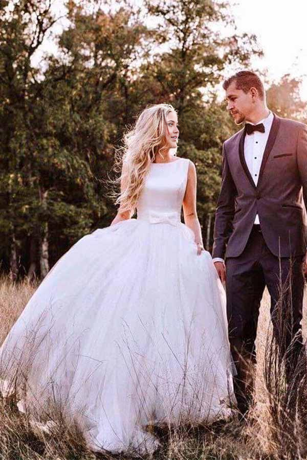 Elegant A-line ivory tulle wedding dress with V-neck and backless design.