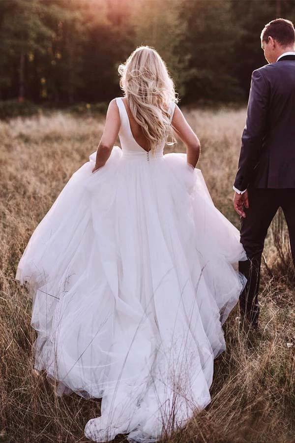 Back view of an A-line ivory tulle wedding dress showing the backless detail.