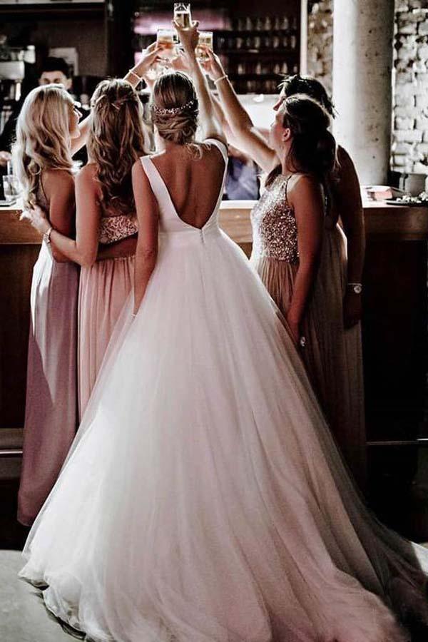 Side profile of a bride wearing an A-line ivory tulle wedding dress.