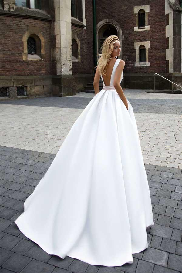 Back view of a simple ivory satin A-line bridal gown.