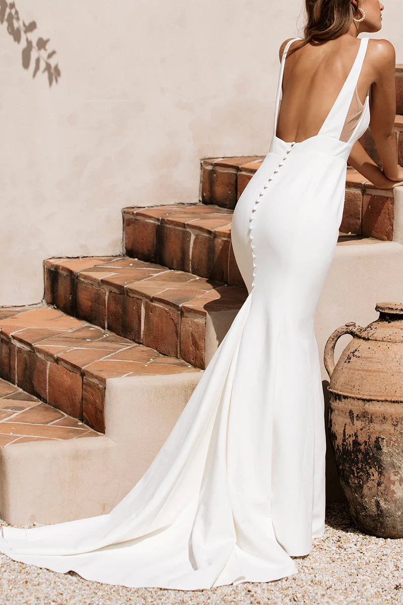 Side view of an elegant sleeveless mermaid wedding gown.