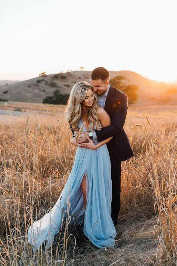 Side view of a bride in a sky blue A-line V-neck wedding dress, showcasing the split and court train.