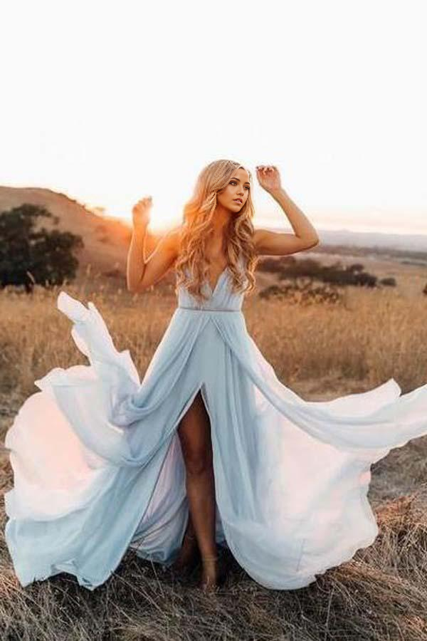 Back view of a sky blue A-line wedding gown with a court train, worn by a model.